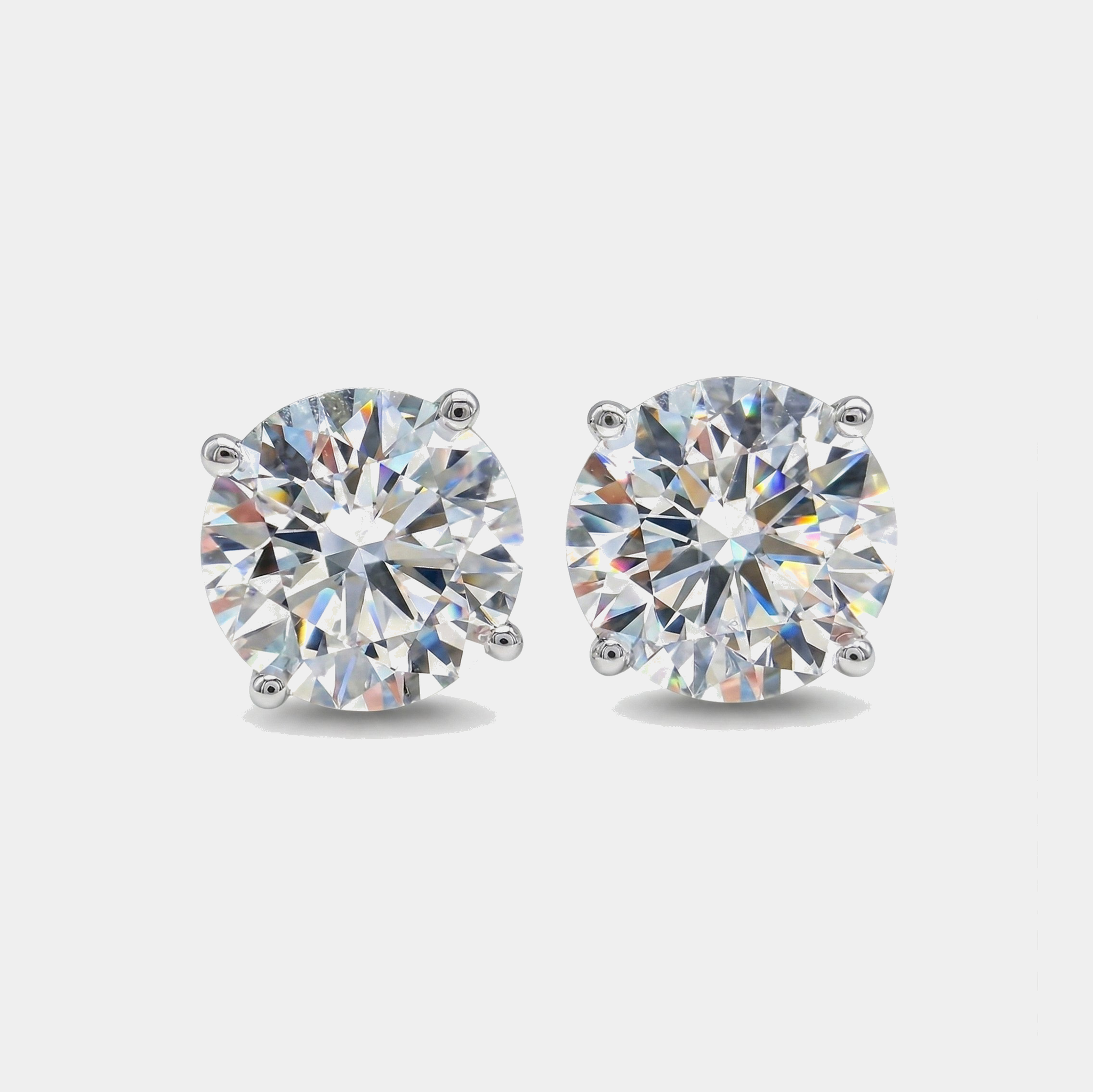 Pair of diamond stud earrings on a light gray background