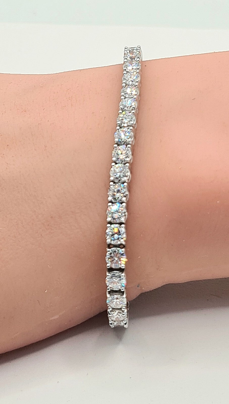 10 carat round brilliant lab grown diamond tennis bracelet worn on the wrist in 14K white gold