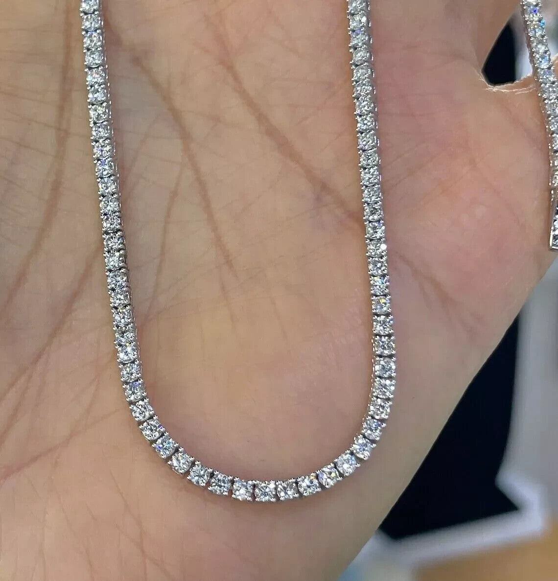 7 carat lab grown diamond tennis necklace held in hand showing the continuous line of round brilliant stones