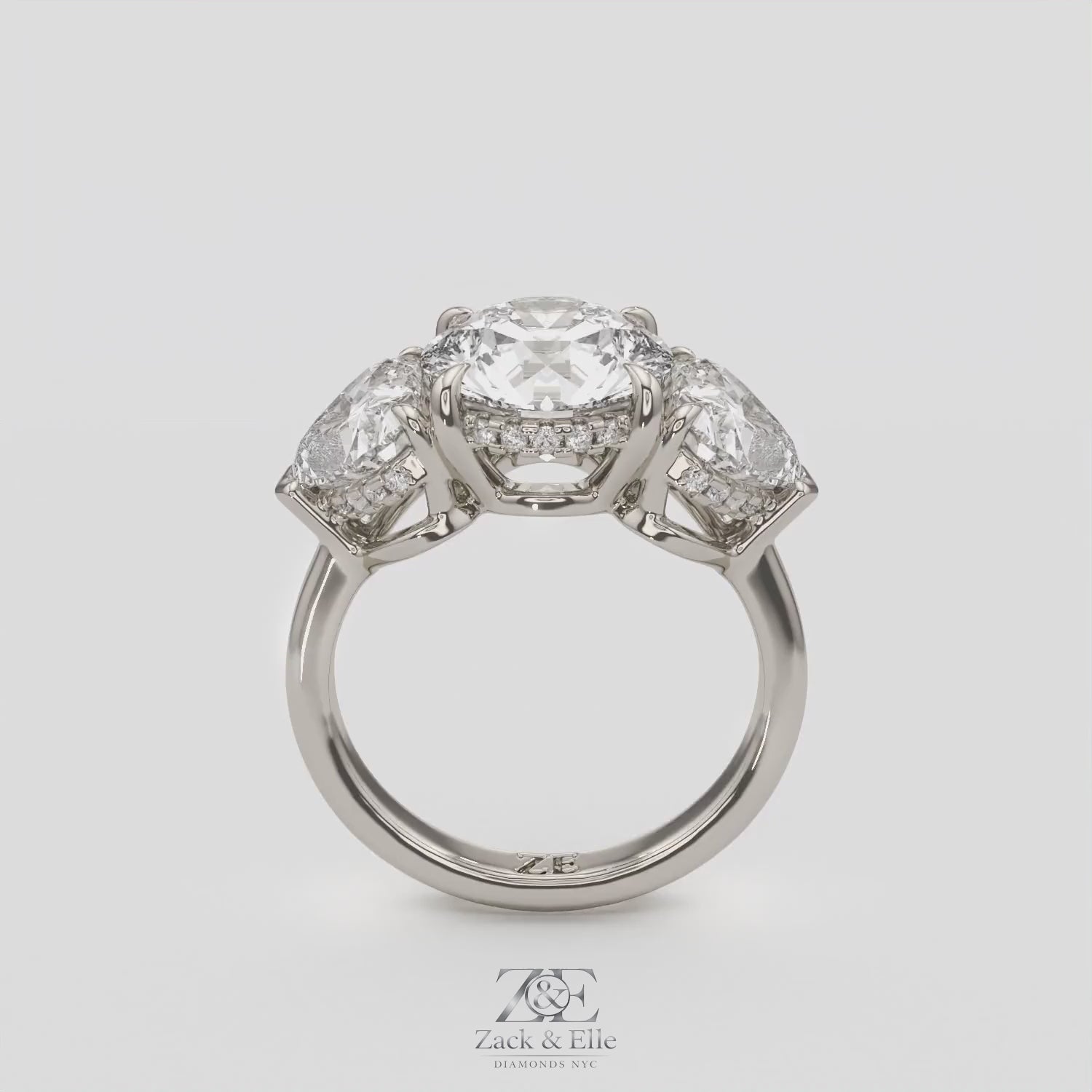 5.20 Ct D VS1 Round Three Stone Ring With Heart Shape Accents and Halo, in white gold, 360 spin