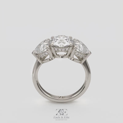 4.15 Ct D VS1 Round 3 Stone Ring With Heart Shape Accents and Halo, in white gold, 360 spin