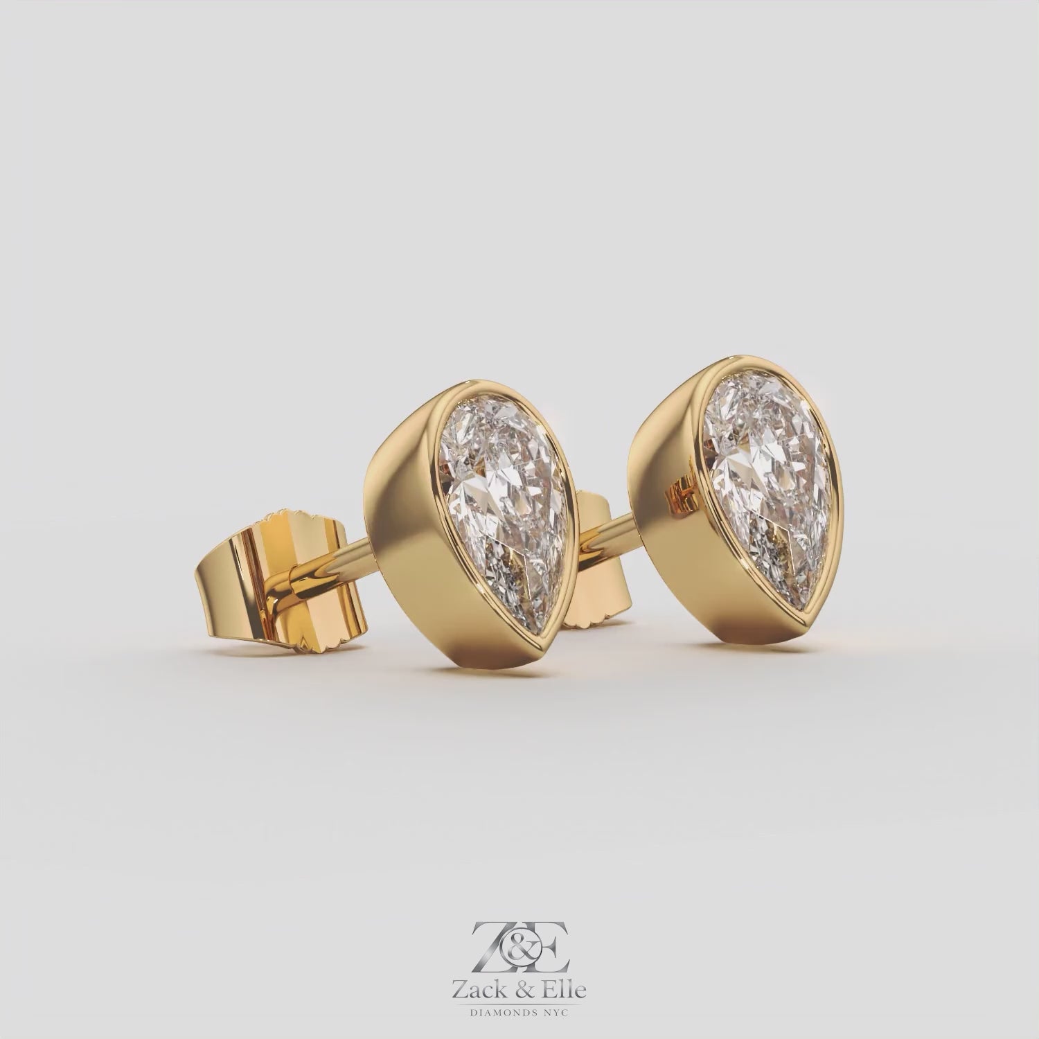 2.00 Ct E VS1 Pear Shaped Full Bezel Lab Grown Diamond Studs, in yellow gold, 360 spin