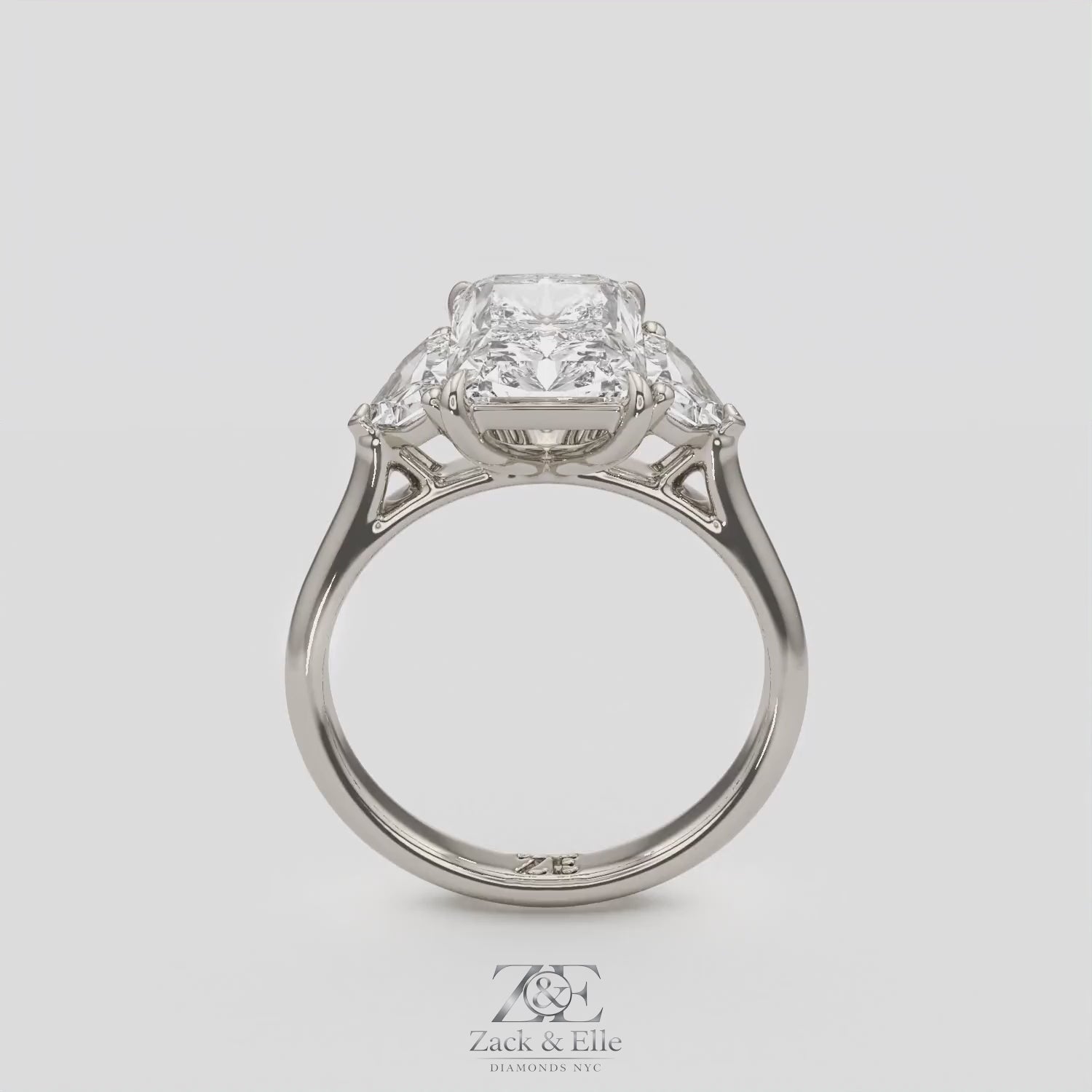 3.50 Ct E VS1 Radiant Three Stone Ring With Trapezoid Accents, in white gold, 360 spin