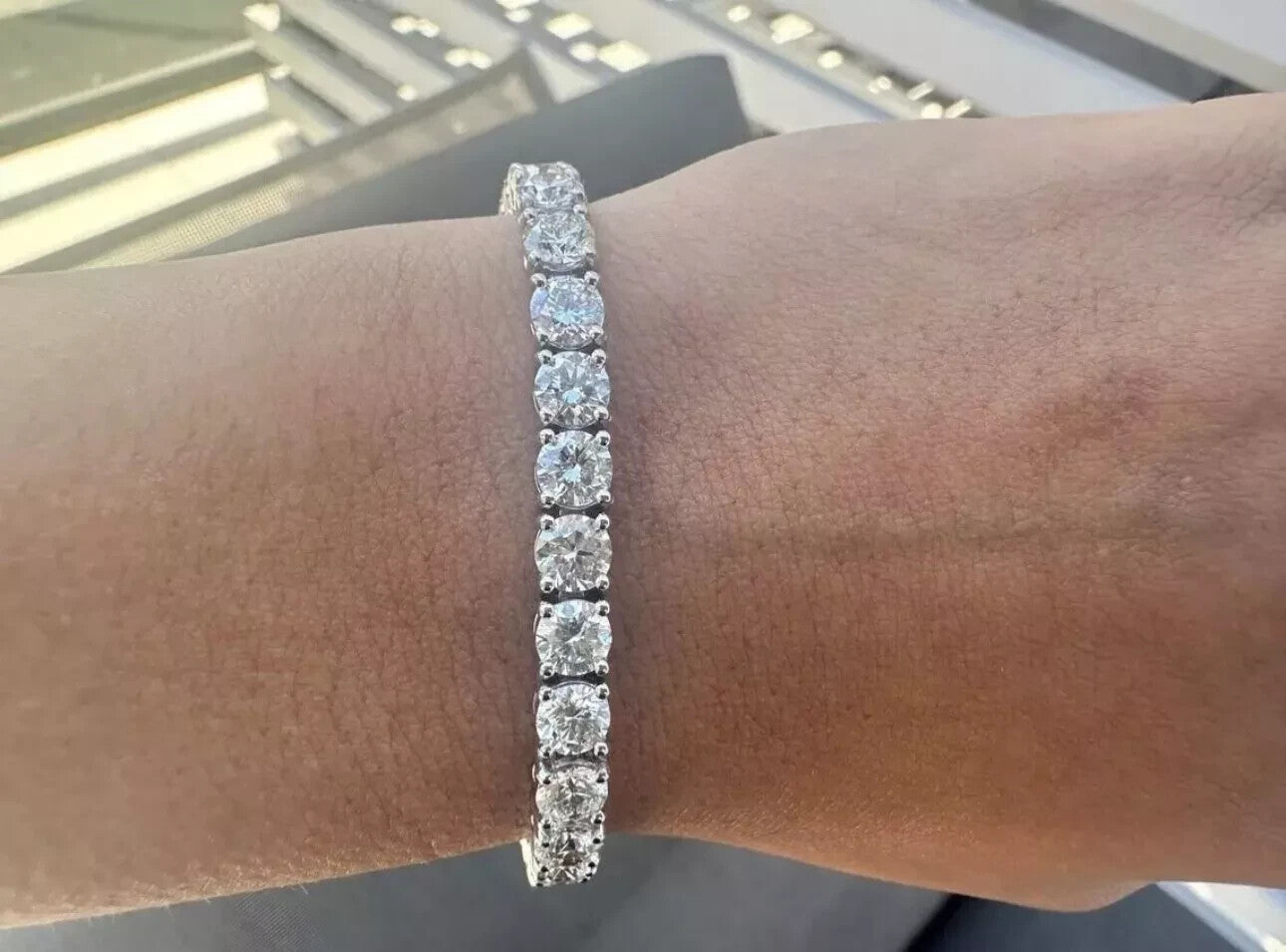 Close up of a 14 carat lab grown diamond tennis bracelet on the wrist in 14K white gold