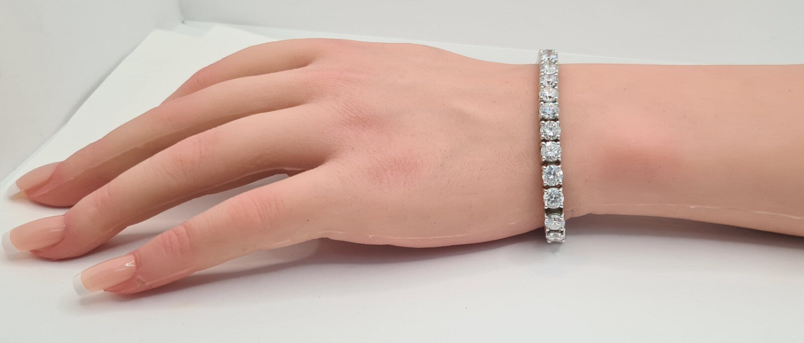 14 carat lab grown diamond tennis bracelet shown on the hand and wrist, 14K white gold
