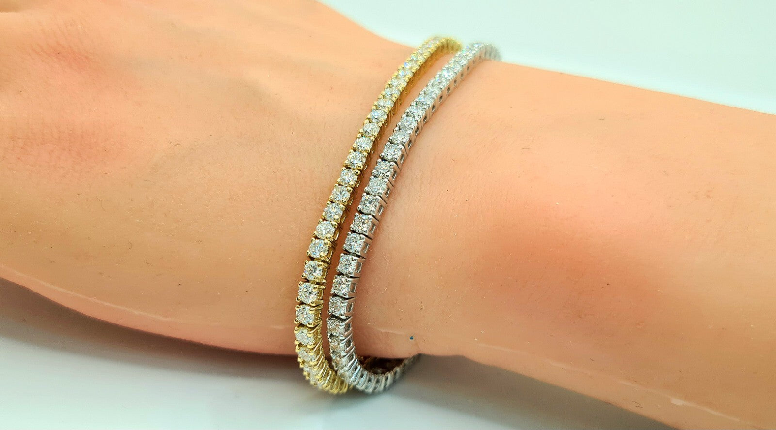 4 carat lab grown diamond tennis bracelets worn on the wrist in 14K yellow gold and 14K white gold
