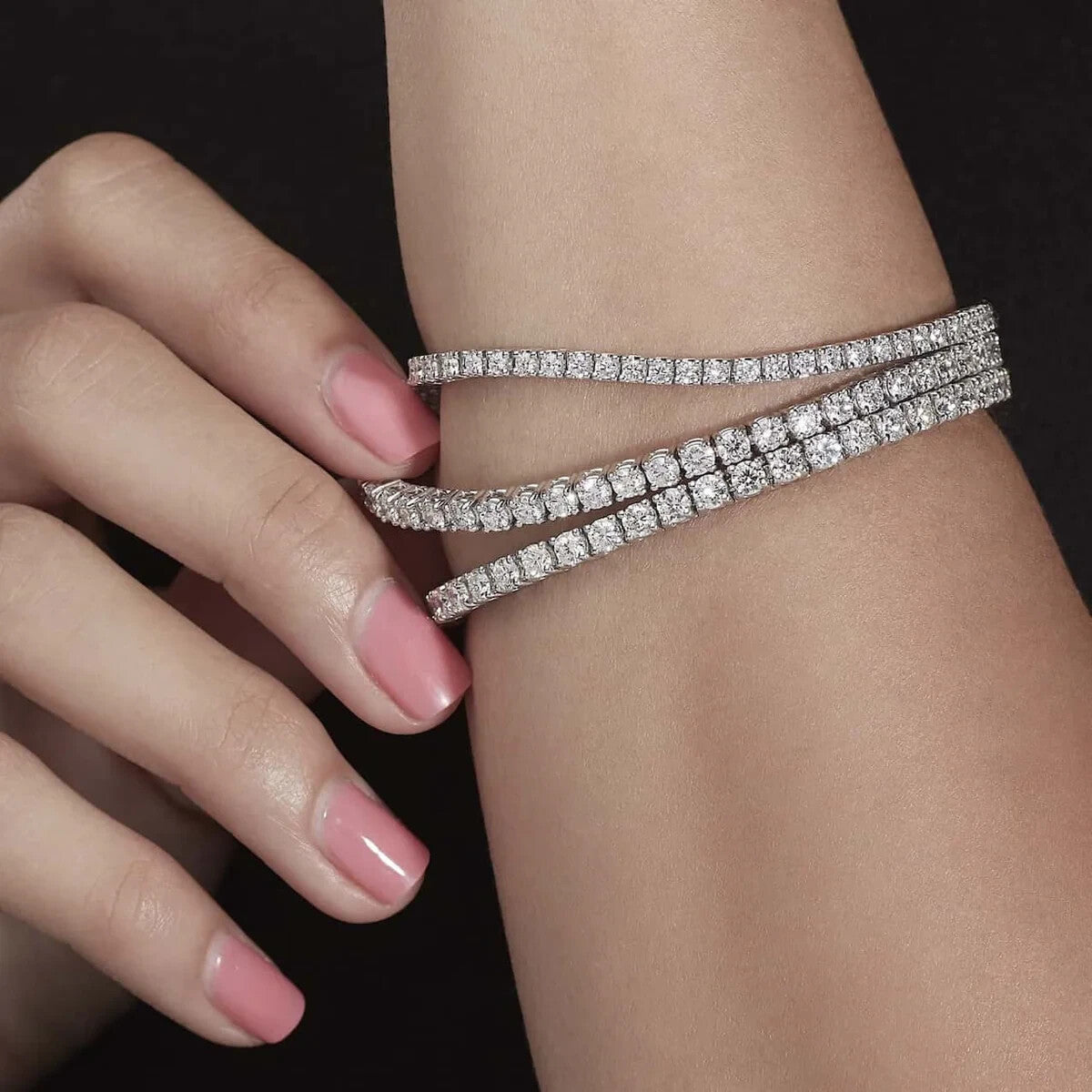 5 carat round brilliant lab grown diamond tennis bracelets worn on the wrist in 14K white gold
