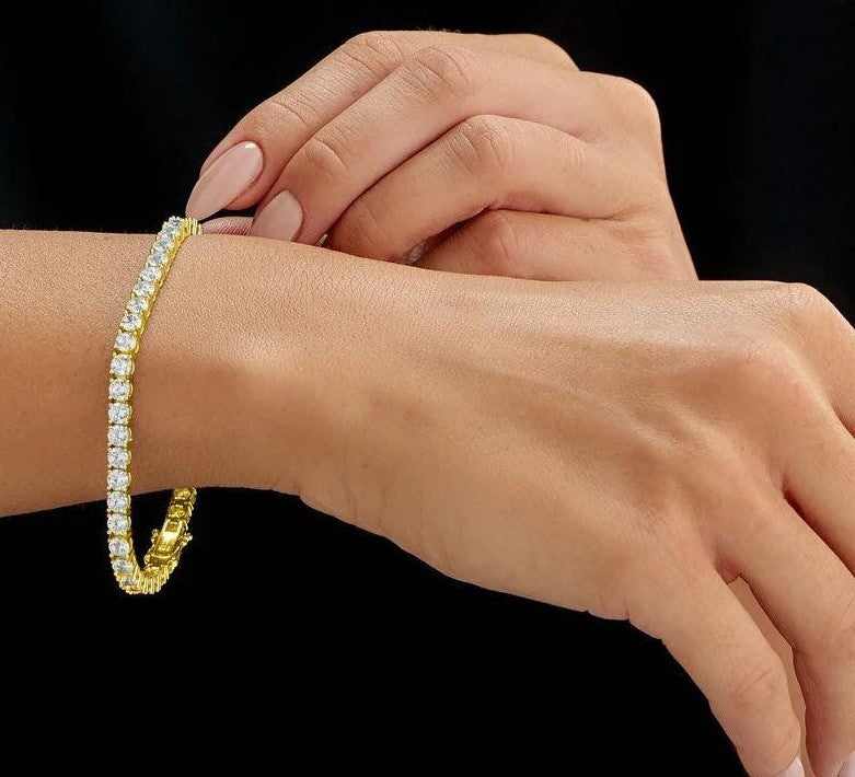 5 carat lab grown diamond tennis bracelet in 14K yellow gold worn on the wrist