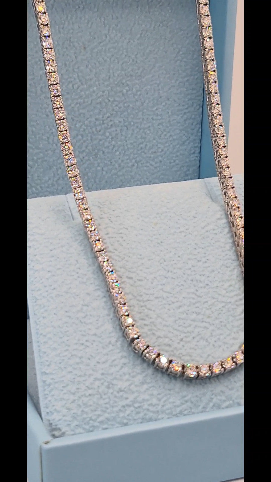 Close up of round brilliant lab grown diamonds set in a 14K white gold tennis necklace