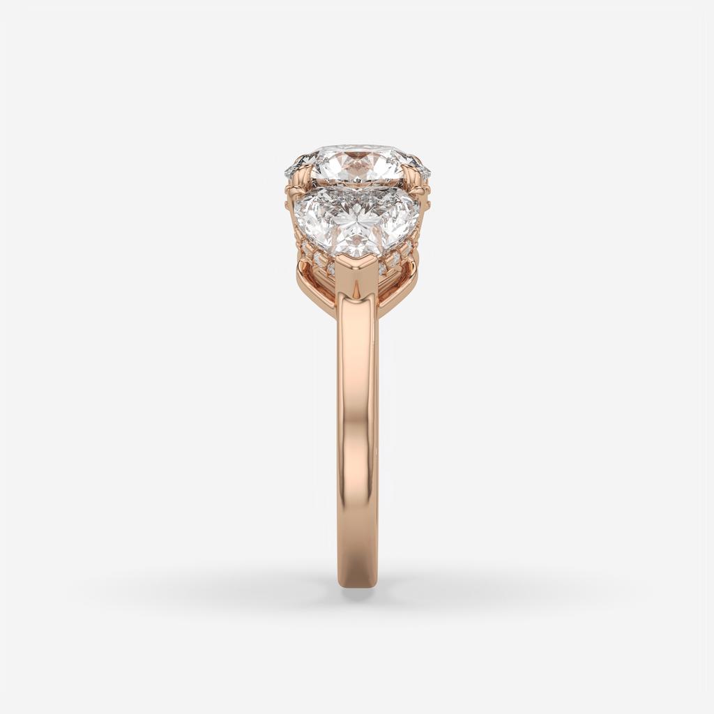 4.15 Ct D VS1 Round 3 Stone Ring With Heart Shape Accents and Halo, in rose gold, side profile
