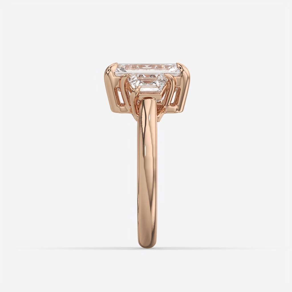 4.60 Ct E VS1 Emerald Cut Diamond Three Stone Ring with Step Cut Trapezoid Accents, in rose gold, side profile